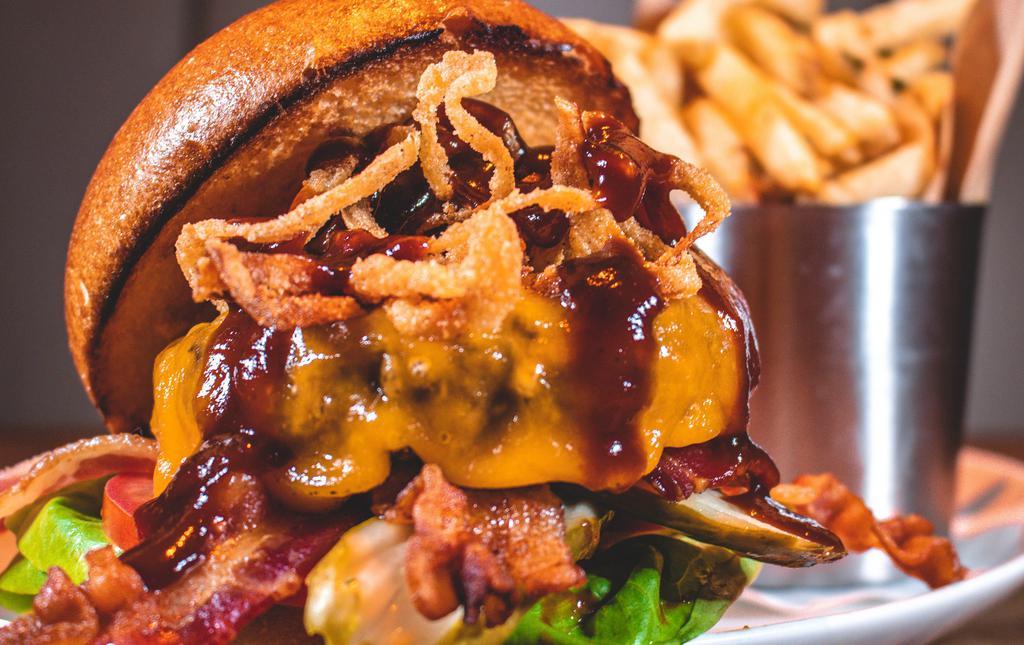 Bbq Burger · Crispy onion strings, bacon, sharp cheddar and BBQ sauce with fries, chips or side salad