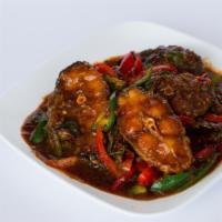 Fried Catfish With Curry Paste · Bone-in catfish slices stir fried with basil, bell peppers, chili, and curry paste.