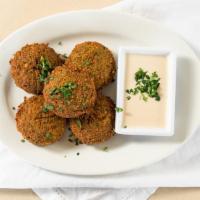Falafel · A deep-fried ball, made with garbanzo beans, mixed with onions, garlic, and parsley, served ...