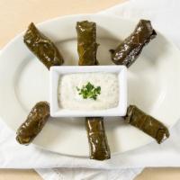 Vegetarian Dolmades · Stuffed grape leaves, with rice and vegetables, served with tzatziki sauce.