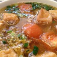 Bun Rieu · Mixed crab, egg with rice stick in tomato crab soup.