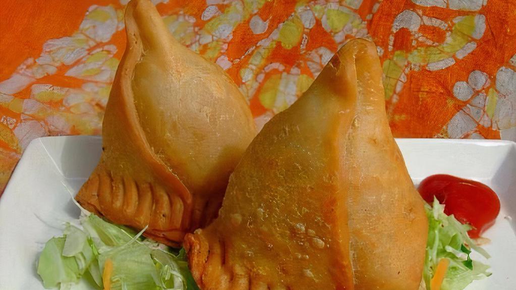 Vegetable Samosa · Deep fried patties stuffed with spices, potatoes and peas. Served with tamarind sauce.
