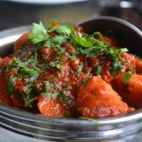 #33. Chicken Vindaloo · Premium chicken cooked in gravy of tomatoes and onions with potato, vinegar,and chili sauce.