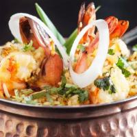 #65. Shrimp Biryani · Shrimp cooked with basmati rice with mix of special herbs and spices. Served with raita.