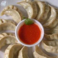Vegetable Momo (8) · Steamed dumplings filled with minced cabbage, spinach, cashews, nuts, paneer, onion, cilantr...