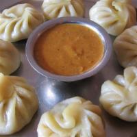 Lamb Momo (8) · Steamed dumplings filled with minced lamb, onion, cilantro, and spices. Served with special ...