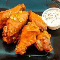 Classic Buffalo · 8 traditional wings tossed in classic buffalo (medium heat), served with  a dipping sauce of...