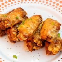 Garlic Parmesan · 8 traditional wings tossed in garlic parmesan (mild heat), served with a dipping sauce of yo...