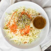 Angel Hair Salad · Gluten-free. Thinly shaved cabbage and carrots with sprouts. Served with our organic garlic-...