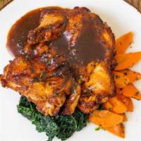 Brick-Pressed Roasted Chicken · Sautéed black kale and carrots with rosemary citrus sauce.