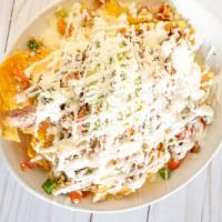 Nachos · Vegetarian. Homemade tortilla chips with beans, melted cheese and your choice of one the opt...