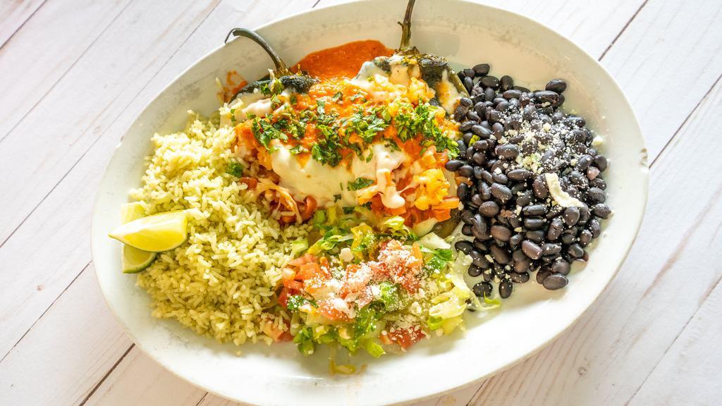 Shrimp Stuffed Chile Rellenos · Gluten free, vegetarian. Our house favorite - two, freshly roasted poblano peppers non-battered and stuffed with shrimp and topped with melted mozzarella cheese. Served over our creamy chipotle sauce with cilantro-lime rice and with tortillas.