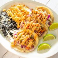 Shrimp Tacos · Vegetarian. Three mini corn tortillas loaded with grilled tiger shrimp in fresh garlic-butte...
