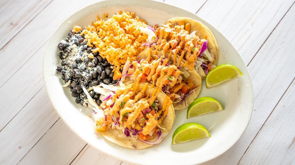 Shrimp Tacos · Vegetarian. Three mini corn tortillas loaded with grilled tiger shrimp in fresh garlic-butter, fresh cabbage, pico de gallo and chipotle aioli. Served with whole black beans and rice.