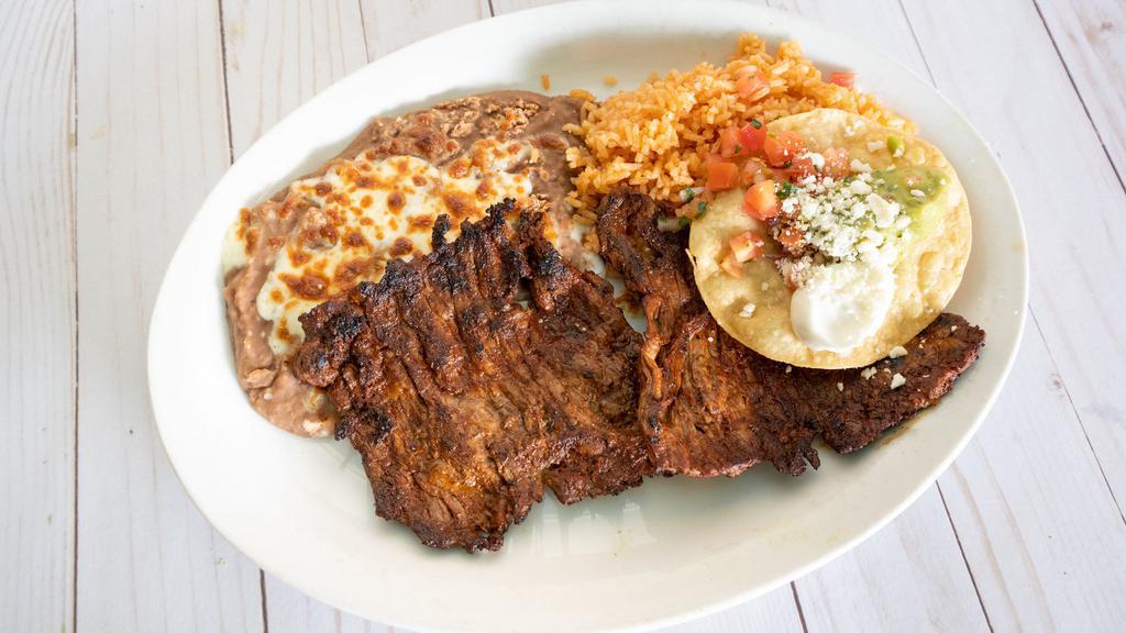 Carne Asada · Gluten free. Tender, marinated skirt steak - grilled and topped with grilled green onion. Served with guacamole, sour cream, pico de gallo, with tortillas and our spicy salsa on the side.