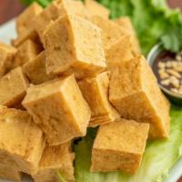 Fried Tofu · Vegetarian friendly. Deep-fried medium firm tofu. Served with crushed peanuts in a sweet and...