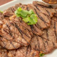 Crying Tiger · Thai style grilled steak. Rib-eye steak marinated Thai style, grilled over an open flame. Se...