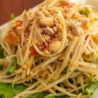 Papaya Salad · Spicy. Shredded green papaya mixed with peanuts, tomatoes, green beans, fresh lime juice, ch...