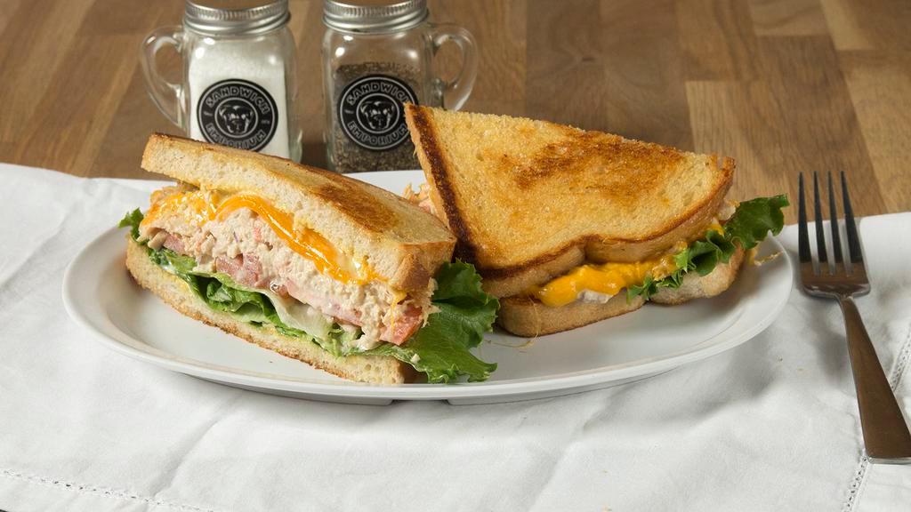 Albacore Tuna Melt · Our house recipe albacore tuna salad, melted cheddar cheese, lettuce, tomato, red onion, mayo, mustard on grilled sourdough.
￼