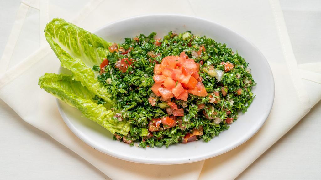 Tabbouleh · Vegetarian. Chopped parsley, cracked wheat, tomatoes, onion, lemon juice, and olive oil.