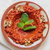 Muhammara · Vegetarian. A spicy dip of crushed walnuts, red pepper paste, and pomegranate molasses.