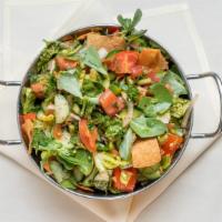 Fattoush Salad · Cucumbers, tomatoes, onions, peppers, parsley, spices, toasted pita chips, and verdolaga (se...