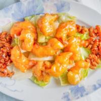 Honey Glazed Walnut Shrimp · Crispy fried shrimp coated in a creamy sweet sauce on top of a bed of lettuce with candied w...