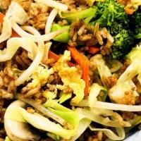Vegetable Fried Rice · Medley of fresh vegetables lightly tossed in our hot iron wok with scrambled eggs and fried ...