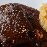 Plato Coloradito · Semi sweet sauce with chicken or pork serves with rice a beans.