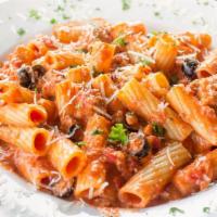 Rigatoni Fra Diavolo · Spicy. Rigatoni pasta tossed with sausage, black olives, and white onions in a spicy, creamy...