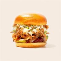 Bbq Pulled Pork Burger · Beef patty with smoked pulled pork, cheddar cheese, fried onions, bacon, and bbq sauce on a ...