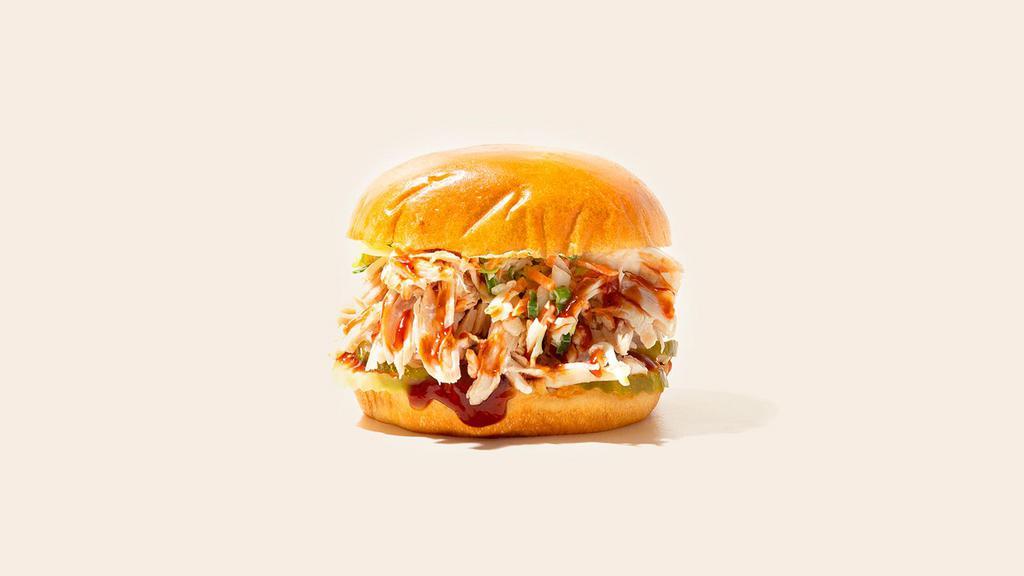 Bbq Chicken Sandwich · Smoked pulled chicken with onions, and bbq sauce on a fluffy bun.