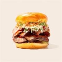 Bbq Chopped Brisket Sandwich · Smoked and chopped beef brisket with coleslaw and bbq sauce on a fluffy bun.