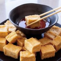 1155. Fried Tofu · A crunchy delight! Served with sweet and sour sauce for dipping.