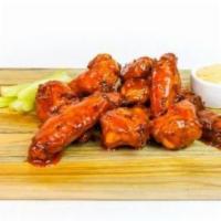 Buffalo Wings · Ten deep-fried crispy wings tossed in buffalo sauce. Served with celery sticks and your choi...