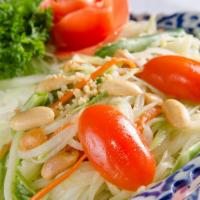 Papaya Salad(Thai Style) · Spicy. Shredded green papaya, carrot,green bean, tomato & ground peanut