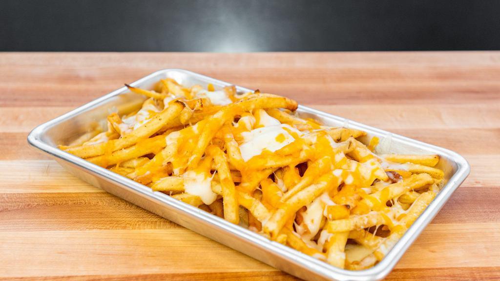 Cheese Fries · Crinkle cut fries topped with melted american cheese sauce