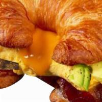 Everything Egg Croissant · Scrambled eggs, swiss cheese, hash brown, bacon, sausage, and avocado. Scrambled eggs contai...