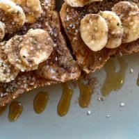 Almond Maple Toast · Two gluten free toasts topped with almond butter, banana, hemp seeds, cinnamon, and a drizzl...
