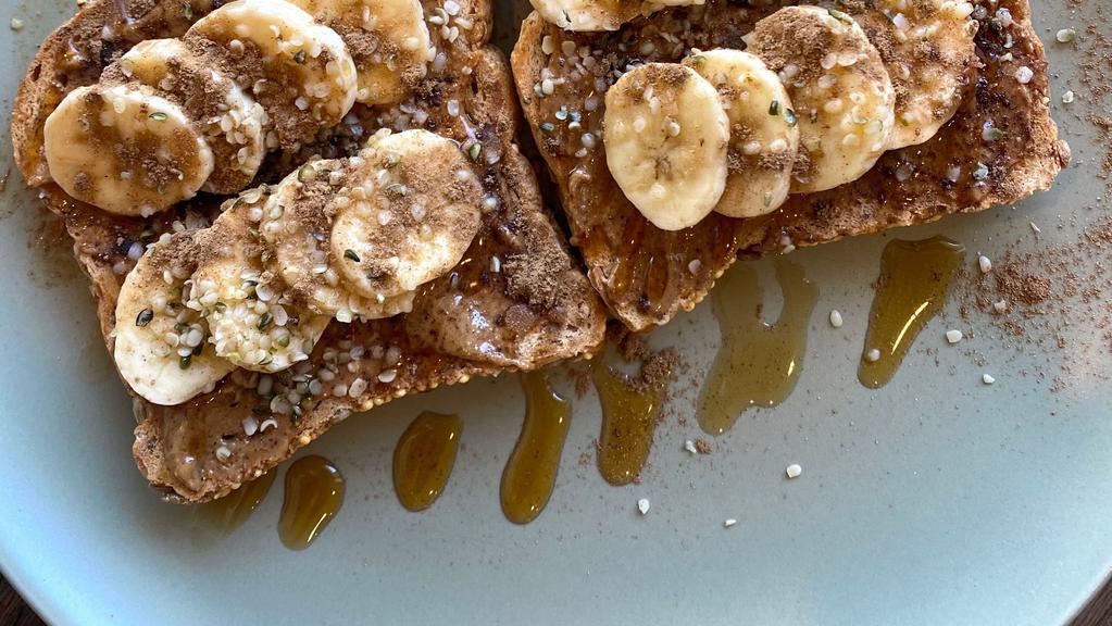 Almond Maple Toast · Two gluten free toasts topped with almond butter, banana, hemp seeds, cinnamon, and a drizzle of pure maple syrup