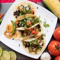 Azteca Vegan Tacos (4) Con Arroz Y Frijoles · Cactus,  beans, and pico de gallo packed into savory meatless taco on the best homemade tort...
