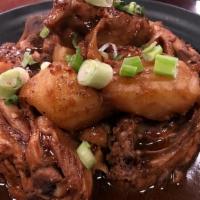 Pork Adobo · Marinated pork chunks slowly cooked in vinegar and soy sauce with garlic, bay leaf, and pepp...