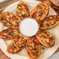 Potato Skins · Loaded with crispy applewood smoked bacon green onions then topped with mozzarella cheddar c...