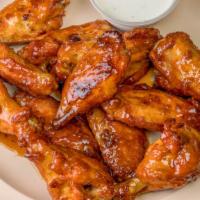 Honey Garlic Wings · Basted in a mildly spicy sweet honey garlic sauce. Served with a side of our homemade ranch ...