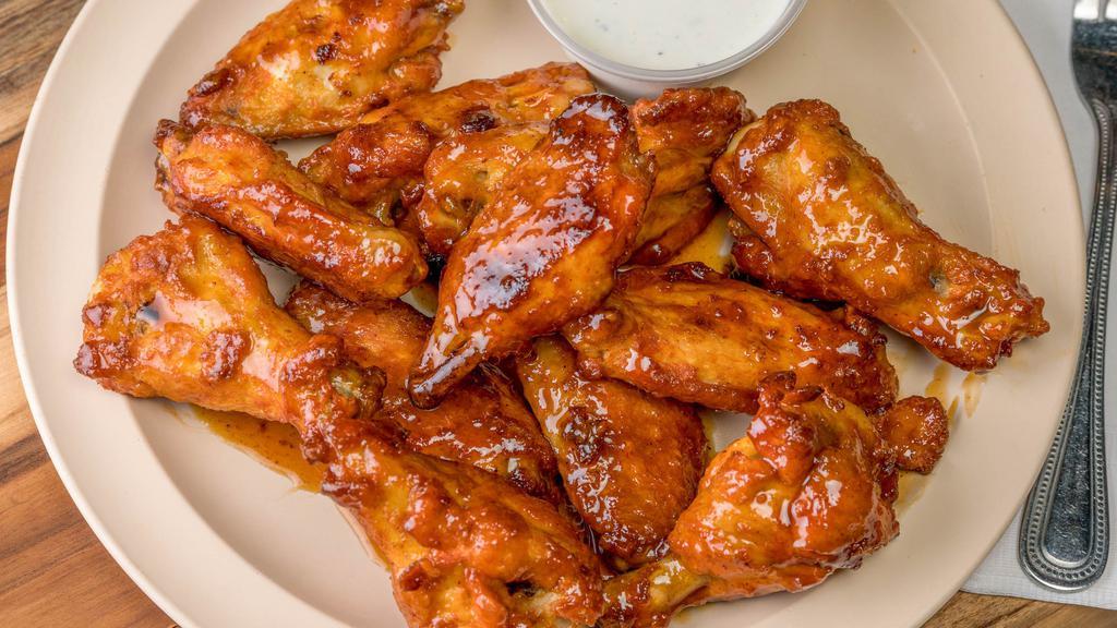 Honey Garlic Wings · Basted in a mildly spicy sweet honey garlic sauce. Served with a side of our homemade ranch dressing.  Addicting!