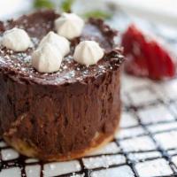 Mousse De Chocolate · Smooth chocolate mousse, imported dark chocolate, sponge cake, meringue pieces, berries.