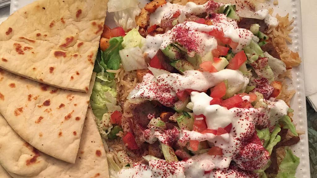 Combination Gyro Plate · Combination of beef and chicken served over rice and lettuce, tomatoes, cucumbers and tzatziki sauce, pita bread provide on the side.