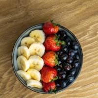 Classic Acai Bowl · Amazonian Acai sorbet served with blueberries, sliced strawberries and bananas, topped with ...