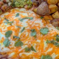 Huevos Rancheros · Corn tortilla, black beans, fried eggs, ranchero sauce, mozzarella, cheddar cheese, guacamol...