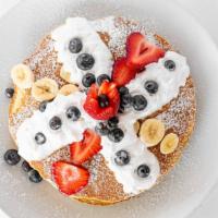 Emles Plain Buttermilk Pancakes · Topped with fresh berries, whipped cream and powdered sugar.